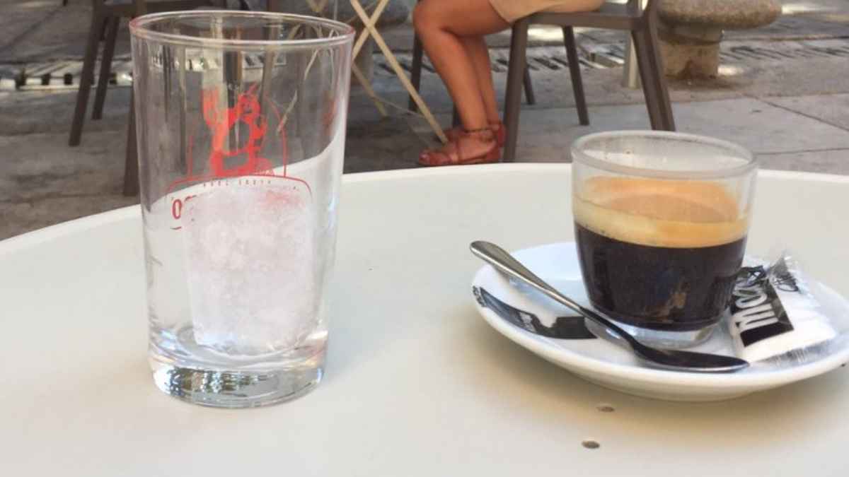 Vaso con hielo y café servido en terraza de bar en España