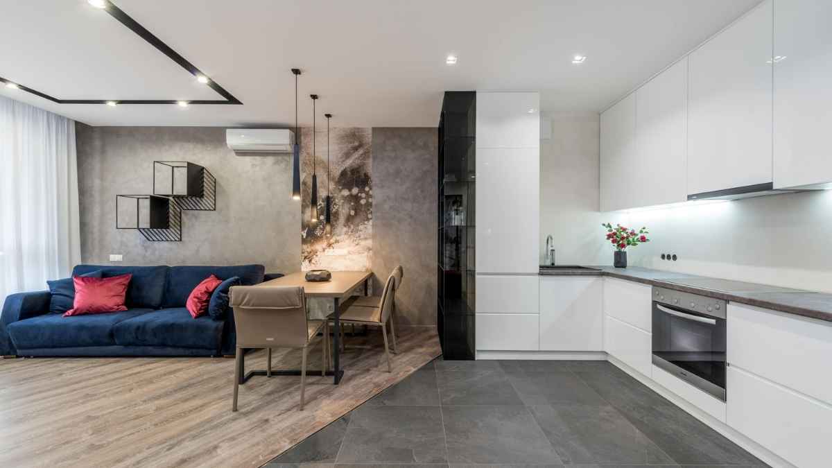 Salón moderno integrado con cocina abierta en vivienda luminosa y actual