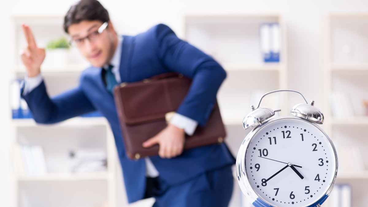 Trabajador saliendo de la oficina con un reloj marcando la hora representando retrasos en el pago de la nómina