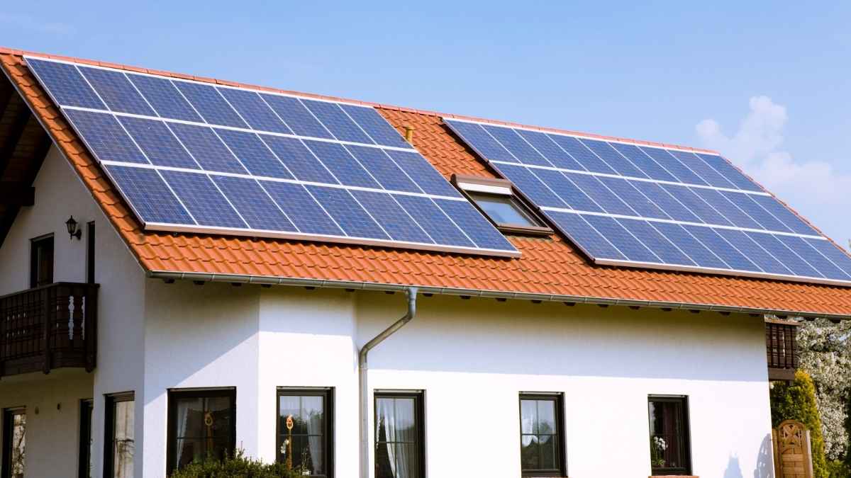 Casa unifamiliar con paneles solares fotovoltaicos instalados en el tejado inclinado