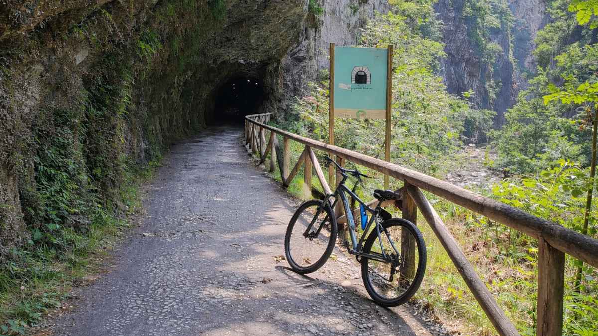 Bicicleta de montaña apoyada en la barandilla de una ruta de montaña, relacionada con el despido de un trabajador en baja médica