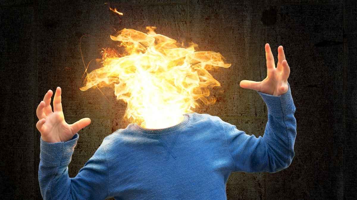 Persona con la cabeza en llamas como metáfora del burnout y la baja médica por salud mental en el trabajo