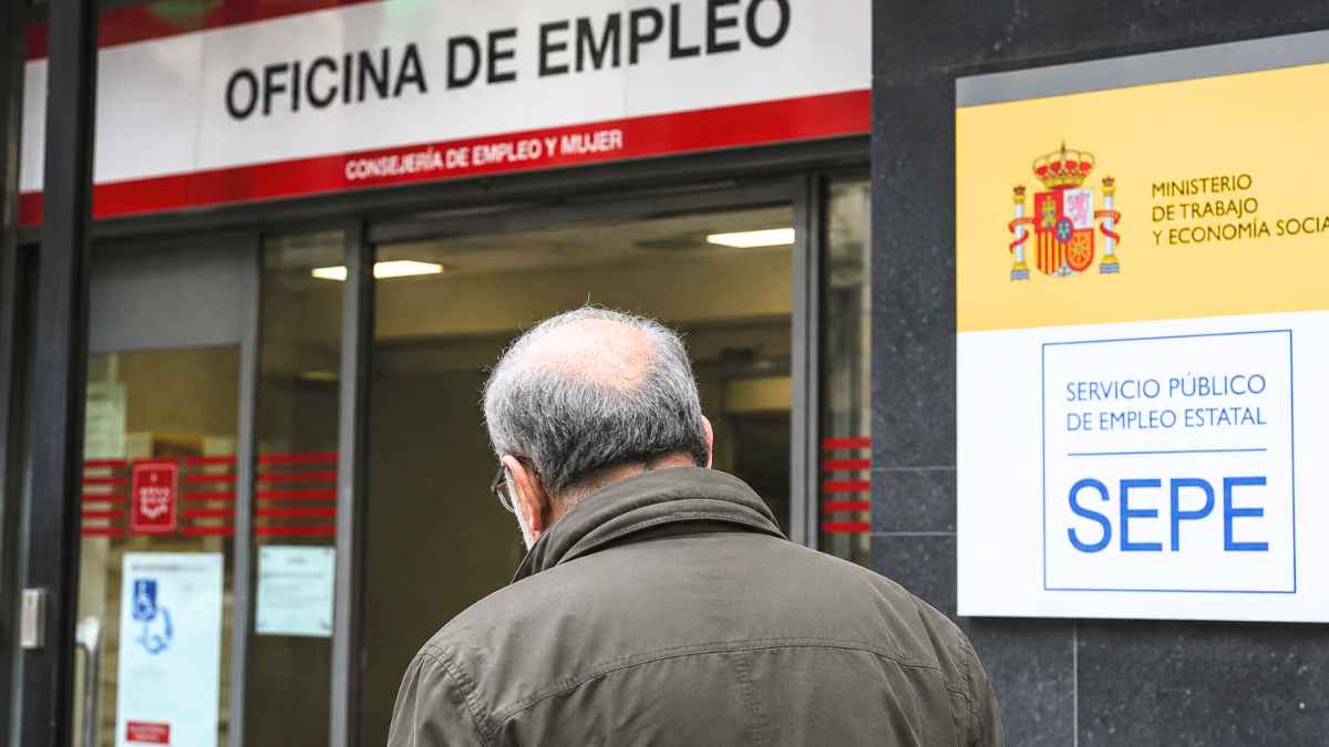 Hombre de edad avanzada entrando en una oficina del SEPE para realizar gestiones relacionadas con prestaciones y subsidios por desempleo.