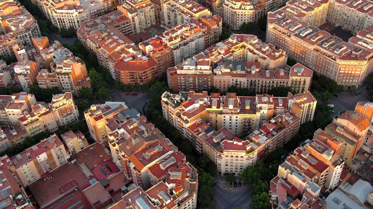 Vista panorámica de Barcelona con la Sagrada Familia y edificios residenciales, ciudad que ofrece ayudas de hasta 9.000 euros para rehabilitar viviendas.